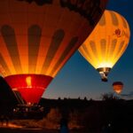 Colorful hot air balloons preparing for flight at sunrise in beautiful Cappadocia, Turkey.